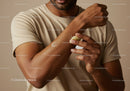 Man Applying Body Lotion for Moisturizing Skin in Close-Up