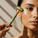 Close-Up of a Woman Using Jade Roller for Skincare Routine with Focused Glow