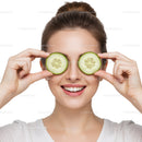 Happy Woman with Cucumber Slices Over Eyes for Natural Facial Skincare