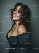 Confident Woman with Curly Hair Smiling in Studio Portrait