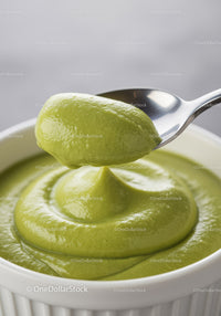 Creamy green avocado mousse in white ramekin with spoon