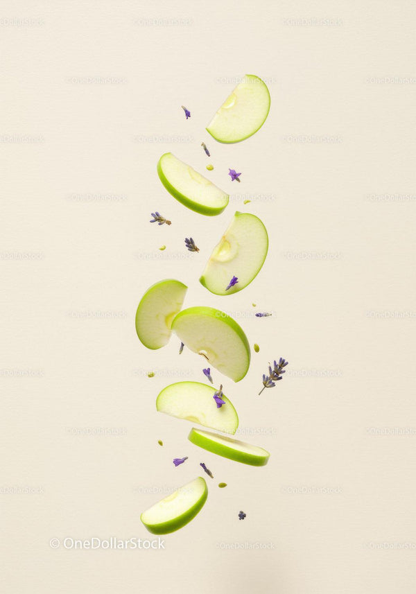 Floating green apple slices with lavender petals