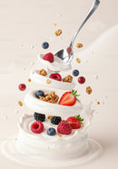 Fresh Berries and Granola Swirling in Cream Splash