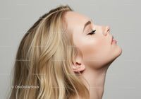 Blonde woman with closed eyes in profile on gray background