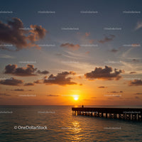 Beautiful Sunset Over Calm Ocean With Pier and Cloudy Sky