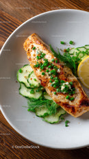 Fresh Grilled Salmon with Cucumber and Lemon on White Plate