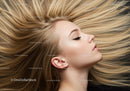 Relaxed woman with flowing blonde hair and closed eyes