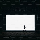 Silhouette of man walking across empty theater stage