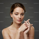 Elegant Woman Applying Moisturizer for Flawless Skin
