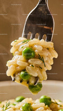 Close-up of creamy risotto with green peas and herbs