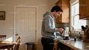 Man Pouring Hot Coffee in Cozy Kitchen at Morning