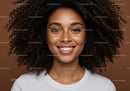 Portrait of a Smiling Woman with Curly Hair and Freckles in Casual Style