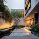 Modern Concrete House with Garden and Balcony in Urban Setting