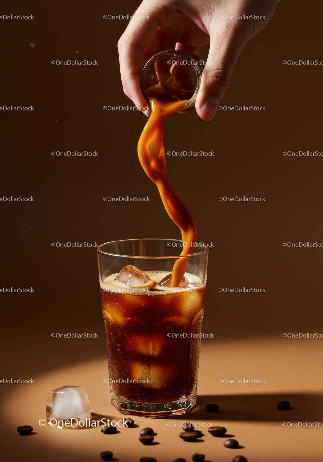 Pouring iced coffee with cream in clear glass