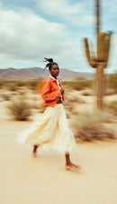 Woman Running in a Desert Landscape with Cacti