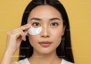 Portrait of Young Woman Applying Eye Mask for Skin Care