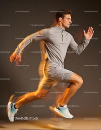 Athlete sprinting with dynamic motion on gray background