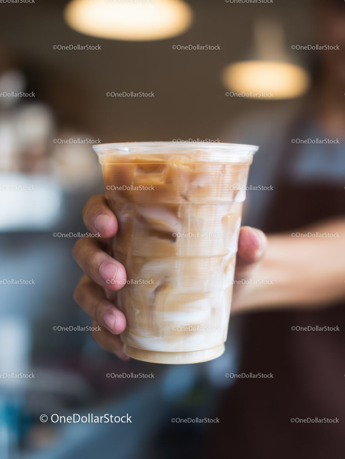 Iced Latte Coffee in Clear Plastic Cup with Swirling Cream