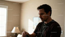 Thoughtful man quietly reflecting in cozy home