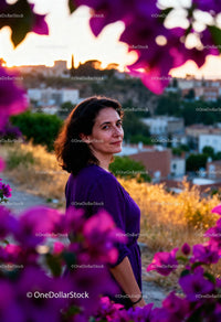 Woman enjoying sunset surrounded by vibrant flowers