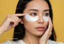 Woman Applying Under Eye Patches for Skin Rejuvenation and Beauty