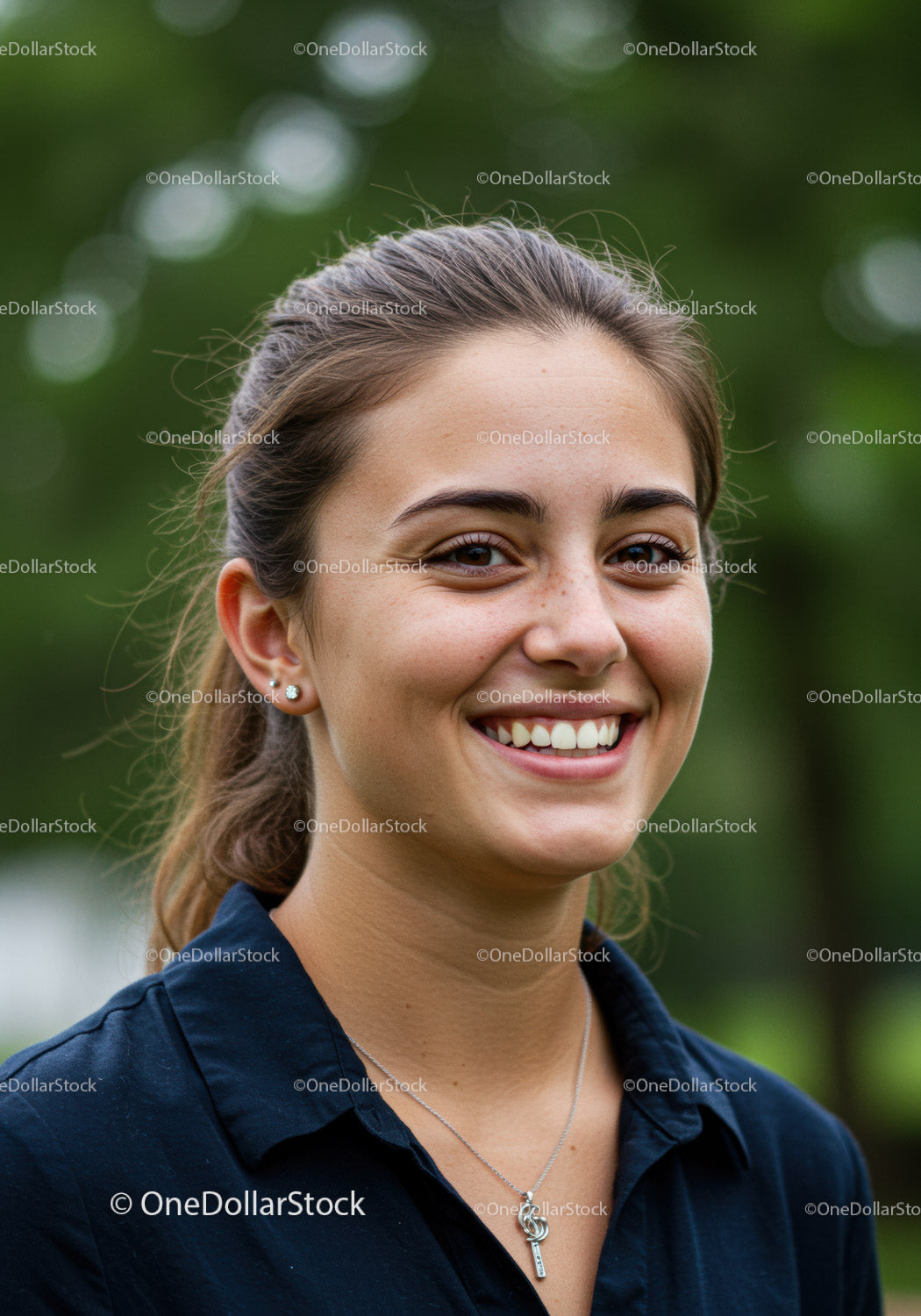Young Woman Smiling Outdoors with Natural Green Backdrop