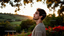 Young man enjoying peaceful sunset in nature