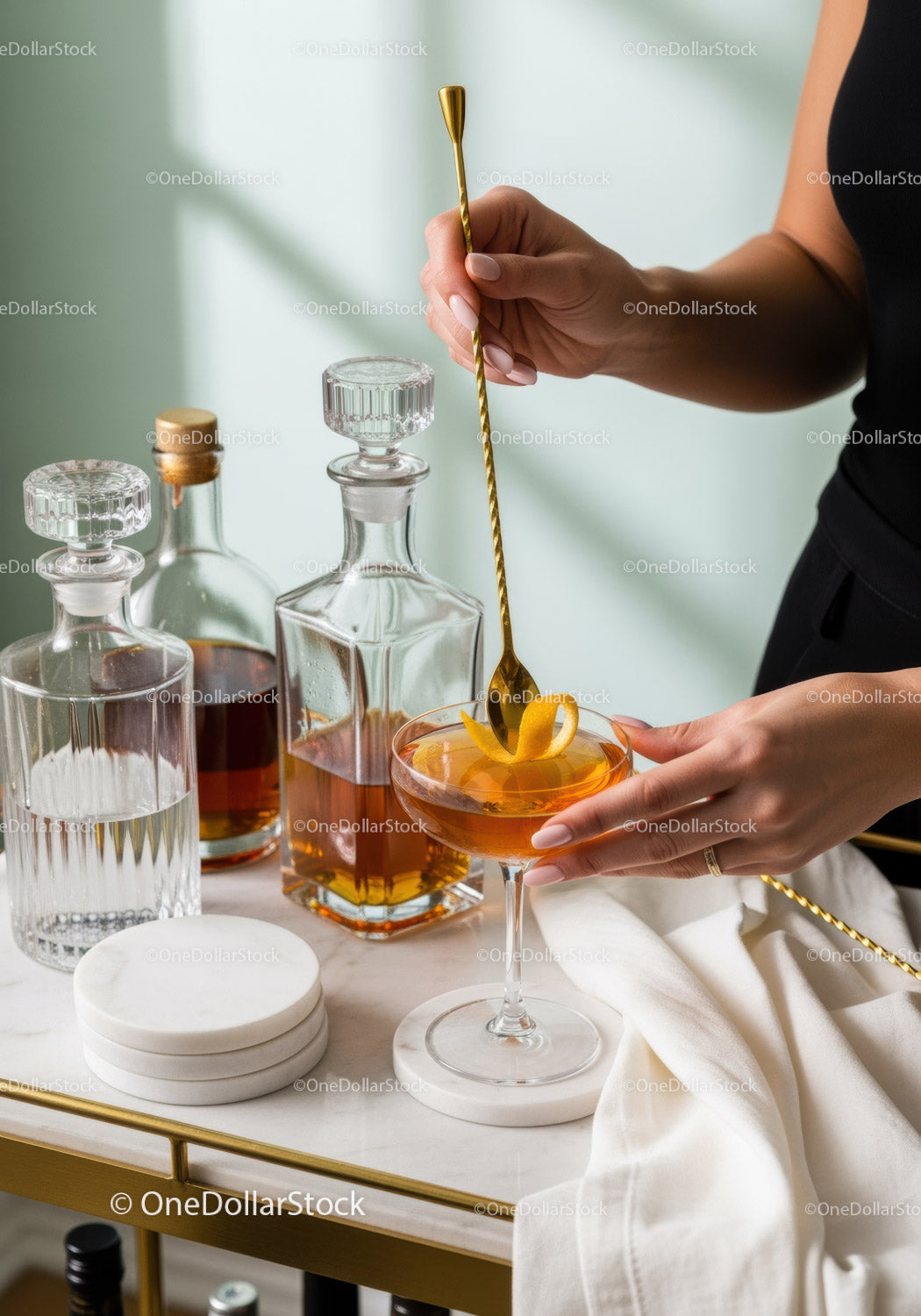 Elegant Orange Cocktail Being Prepared with Golden Spoon in Stylish Setting