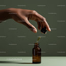 Hand Holding Dropper Filling Amber Glass Bottle for Skincare