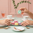 Elegant Assorted Macarons on Pastel Green Table with Tea Sets