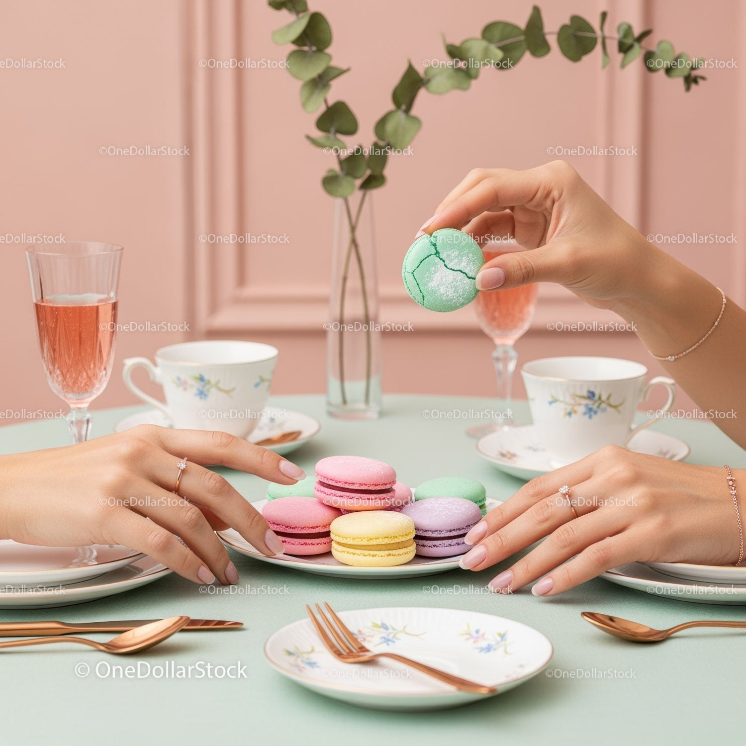 Elegant Assorted Macarons on Pastel Green Table with Tea Sets