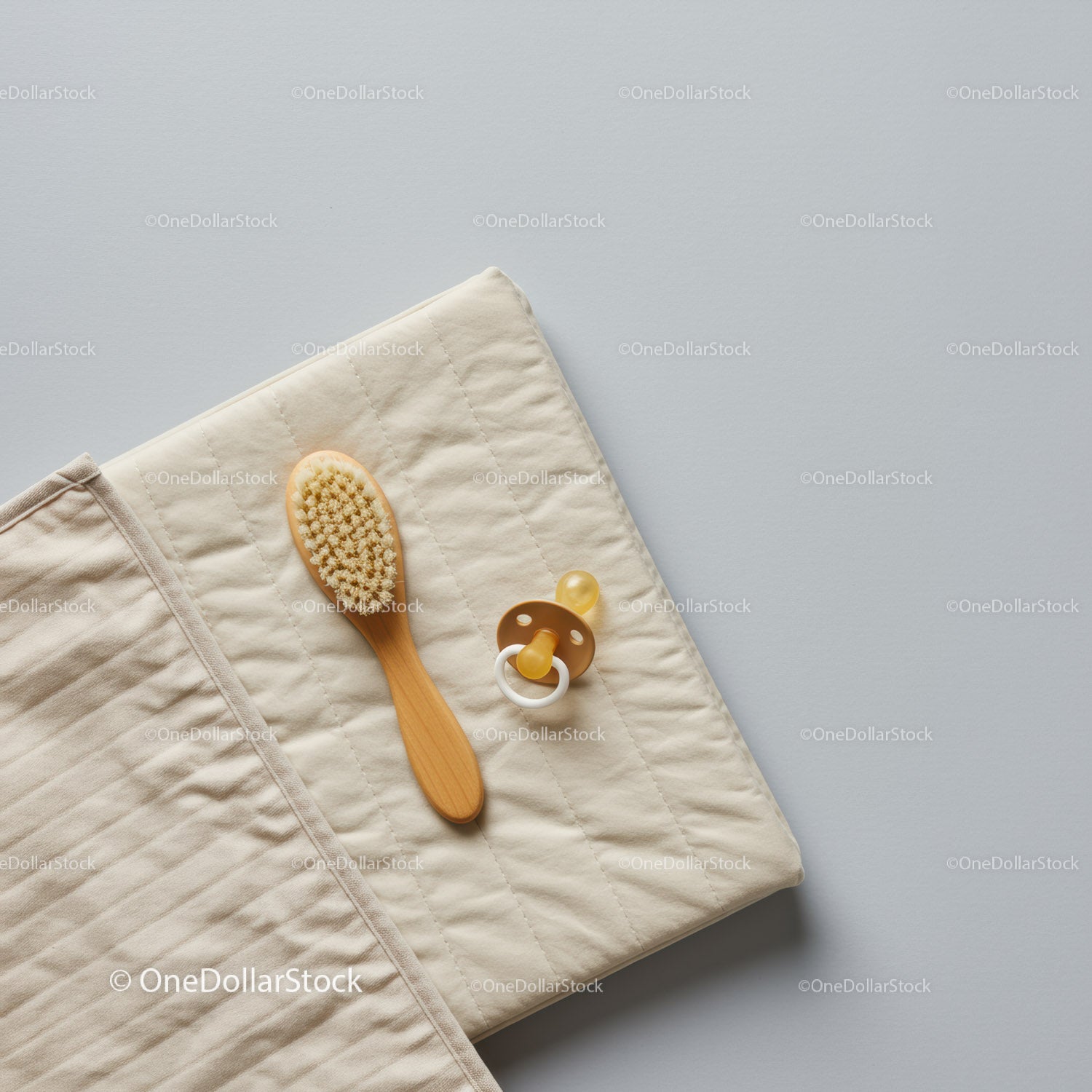 Natural baby brush and pacifier on changing mat