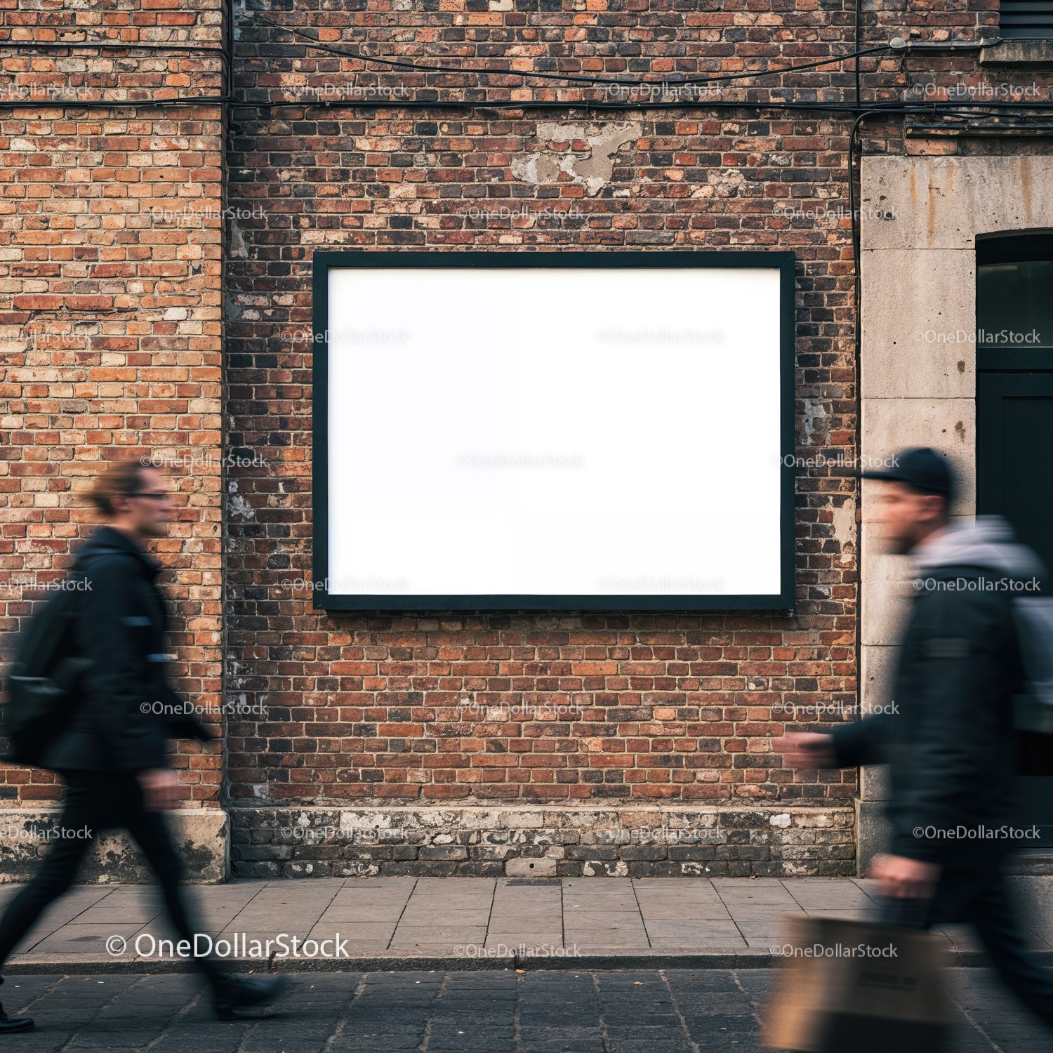 Empty billboard on brick wall with blurred passersby