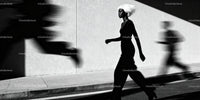 Woman with White Hair Walking Against Light Wall