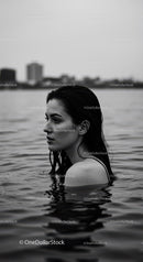 Serene Female Portrait in Water with Urban Background
