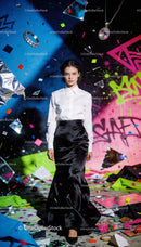Elegant woman walking through vibrant urban art scene