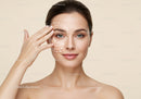 Elegant Woman Receiving Facial Skincare Treatment with Relaxed Expression