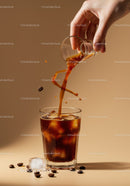 Pouring Cold Brew Coffee Over Ice Cubes