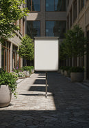 Blank signboard in quiet urban courtyard with greenery
