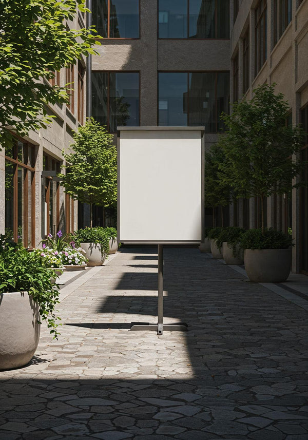 Blank signboard in quiet urban courtyard with greenery JPG Mockup Image