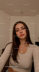 Young woman with long hair posing indoors
