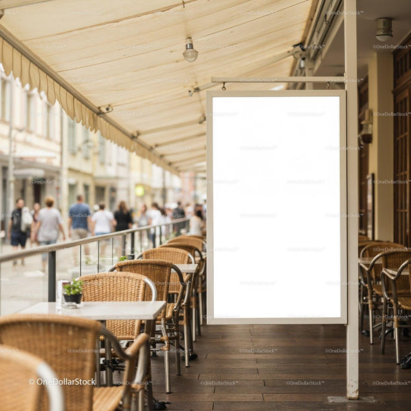 Empty outdoor cafe seating with blank advertising board JPG Mockup Image