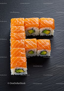 Fresh salmon sushi rolls arranged in a letter F shape