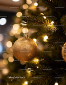 Golden Christmas Ornament Hanging on Festive Tree
