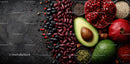 Fresh Organic Ingredients with Avocado and Pomegranate on Dark Surface
