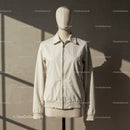 Minimalist beige jacket on mannequin with natural light
