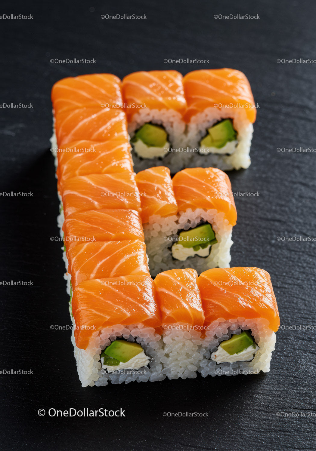 Fresh salmon sushi rolls arranged in letter shape