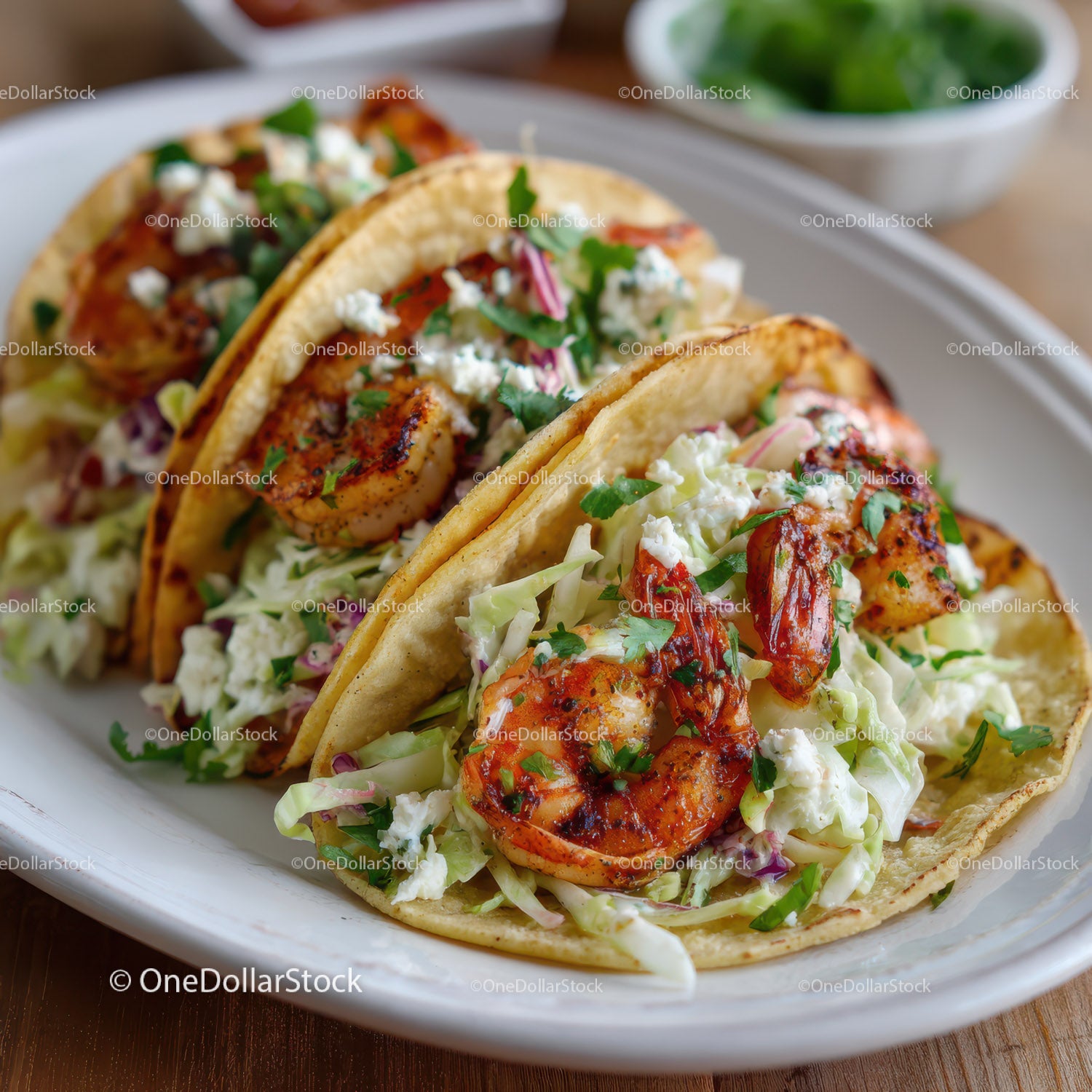 Fresh Shrimp Tacos with Lettuce and Cilantro on White Plate