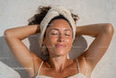 Woman Relaxing During Spa Day With Towel on Head Beauty Routine