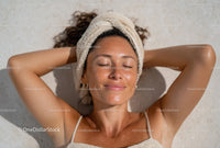 Woman Relaxing During Spa Day With Towel on Head Beauty Routine